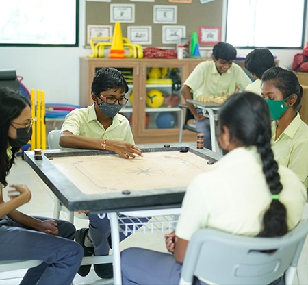 Students playing Carrom