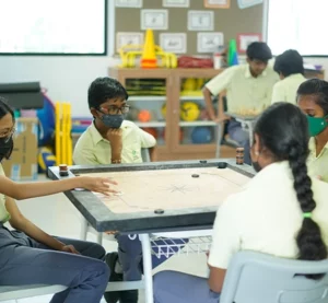 Students playing Carrom
